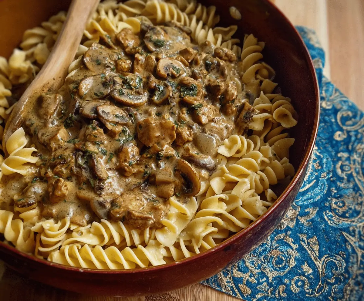 Creamy mushroom and seitan stroganoff served in a bowl with fresh herbs, perfect for a vegetarian comfort meal.