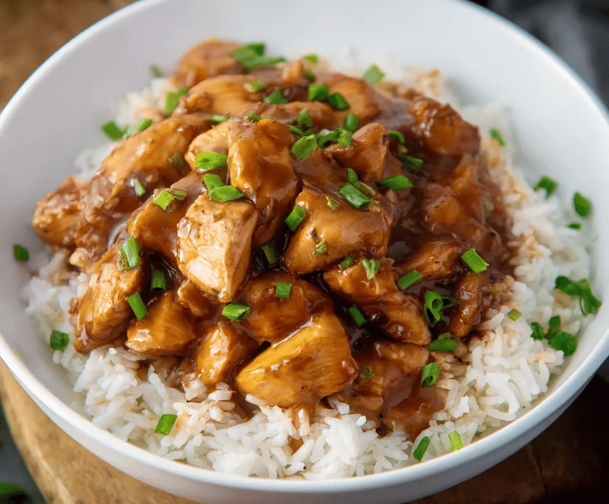 Delicious homemade Crock Pot Bourbon Chicken served with steamed rice and vegetables, perfect for a flavorful dinner recipe