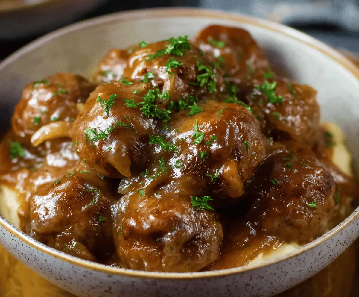 Delicious Crockpot French Onion Meatballs served in a bowl with caramelized onions and melted cheese, perfect for a flavorful appetizer or main dish