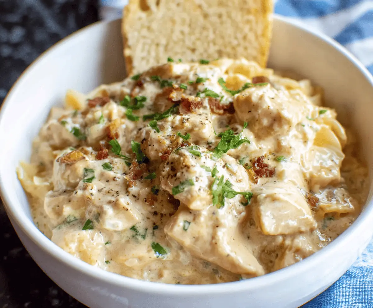 Creamy ranch chicken cooked in a crockpot, served with fresh herbs and side dishes, perfect for a flavorful and easy dinner recipe.