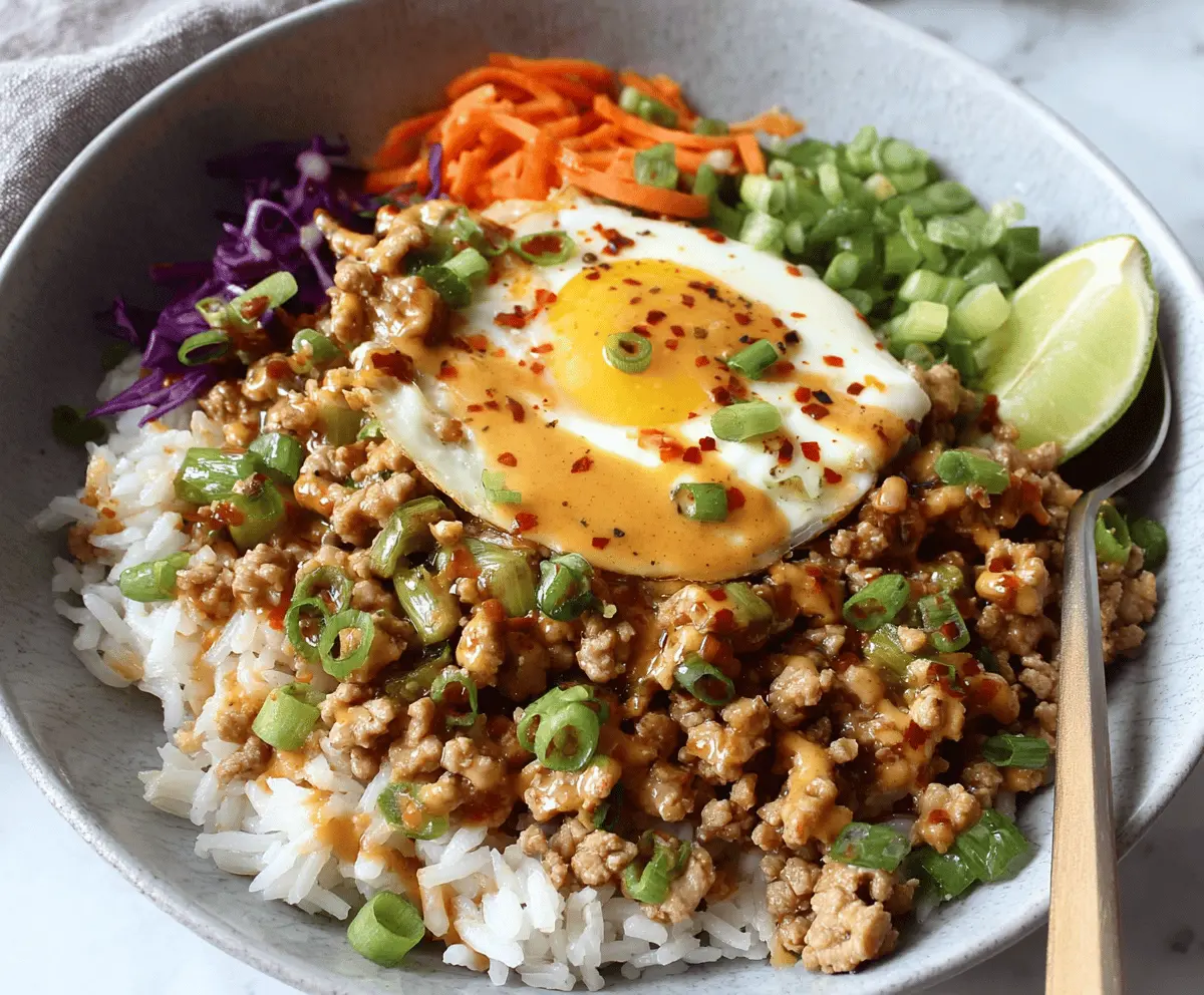 Delicious ground turkey rice bowl topped with creamy Bang Bang sauce on a plate.