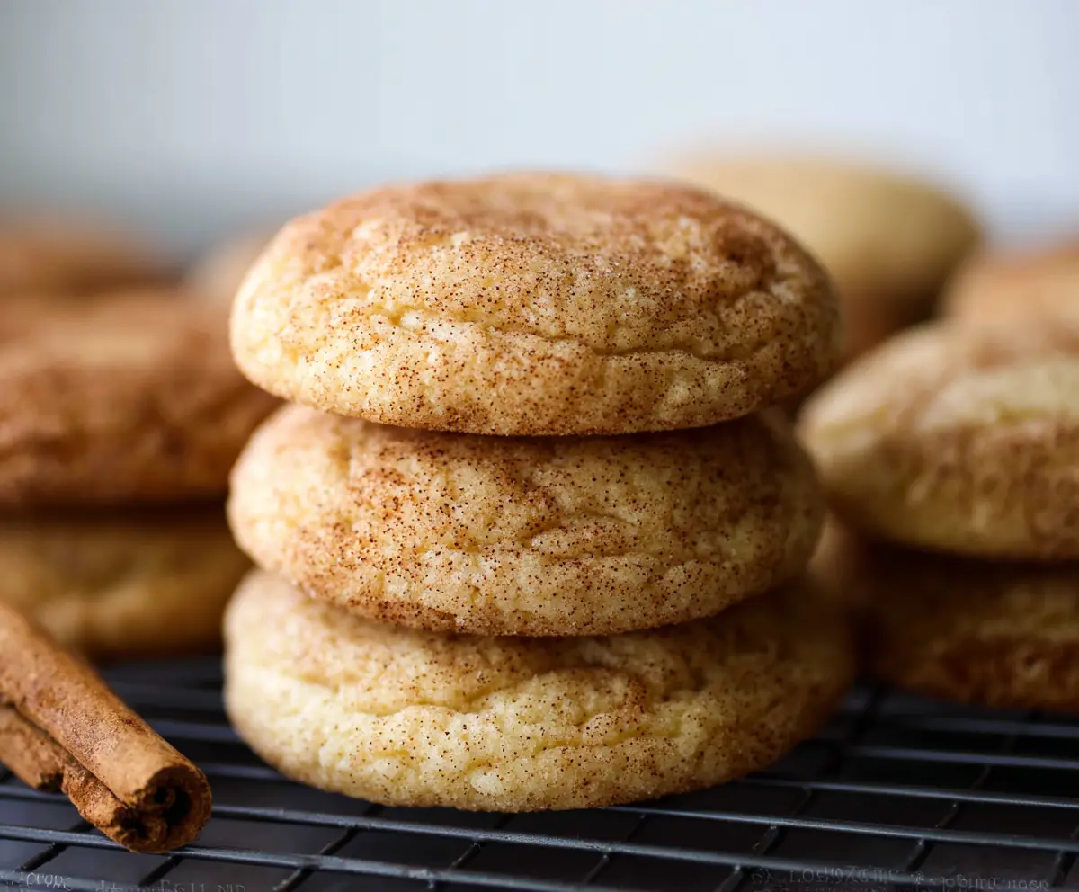 Delicious homemade snickerdoodle cookies with cinnamon sugar coating on a rustic plate.