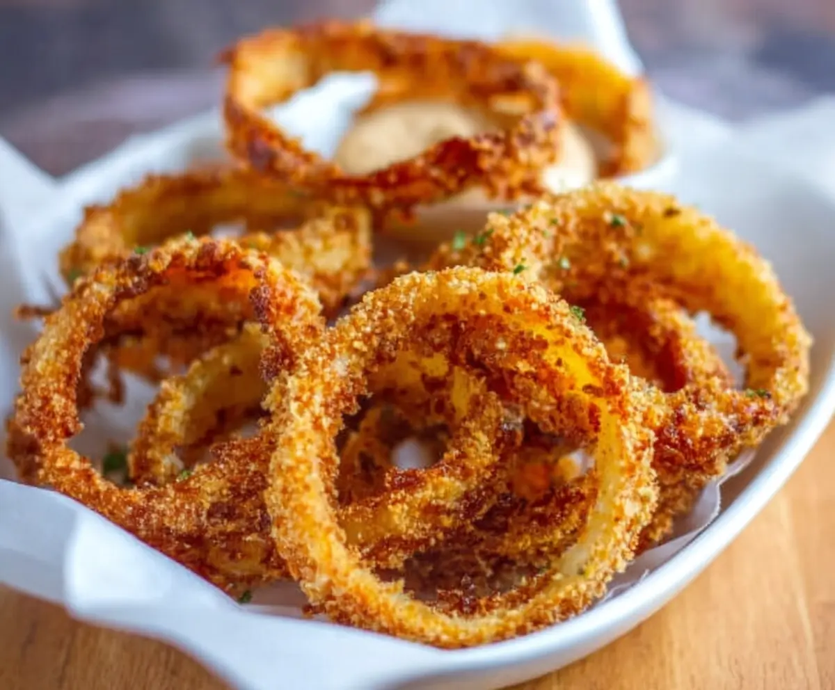 Crispy keto onion rings on a plate, perfect low carb appetizer for healthy snacking.