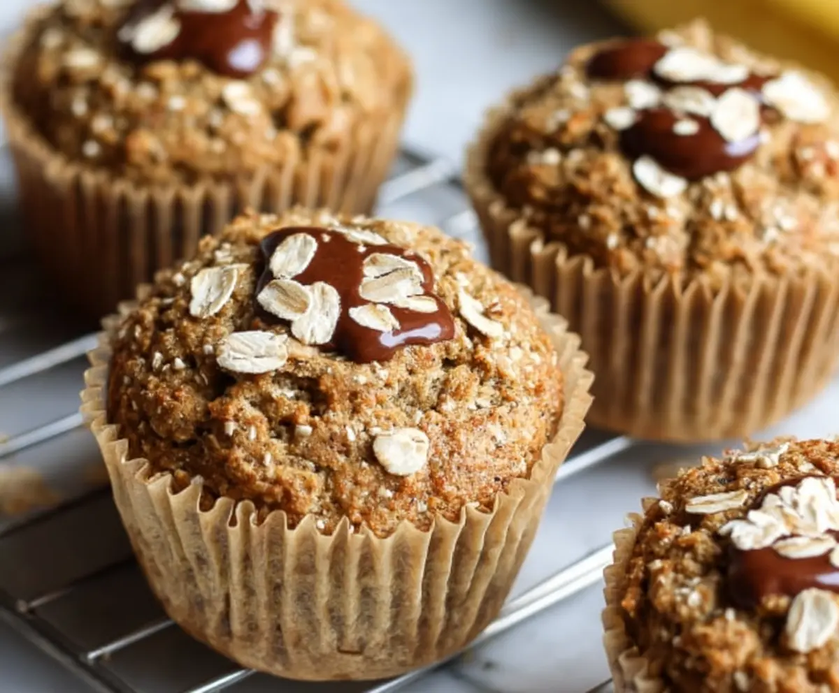 Healthy banana oatmeal muffins freshly baked, featuring ripe bananas and oats in a clear view.