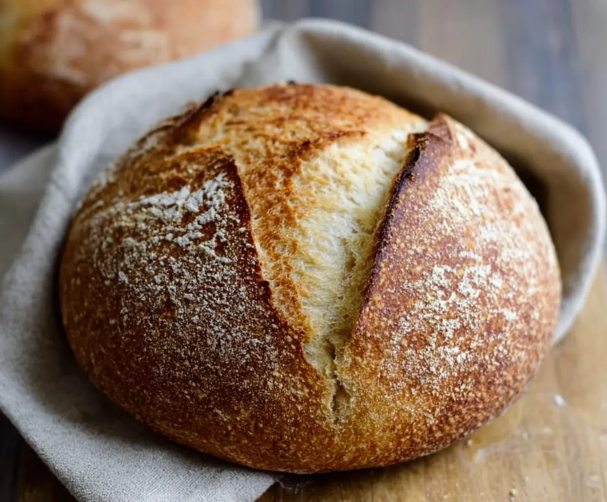 Homemade sourdough bread fresh out of the oven, showcasing a golden crust and airy interior